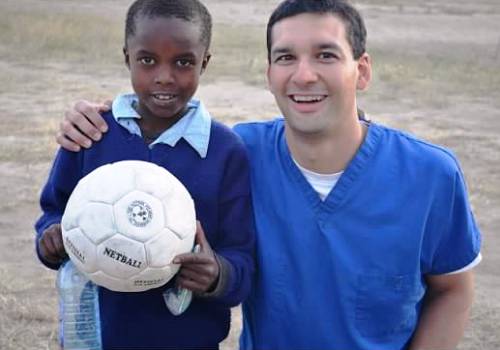Mission Trip - Dr. Vostatek and boy with soccer ball